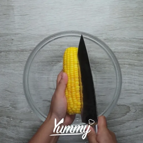 Ambil biji jagung ddengan bantuan pisau sesuai alurnya agar jagung tidak terpotong sehingga bentuk bijinya utuh.