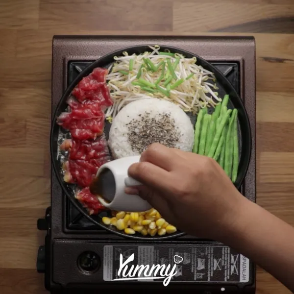 Siram dengan saus. Aduk merata selagi hotplate masih panas dan daging matang.