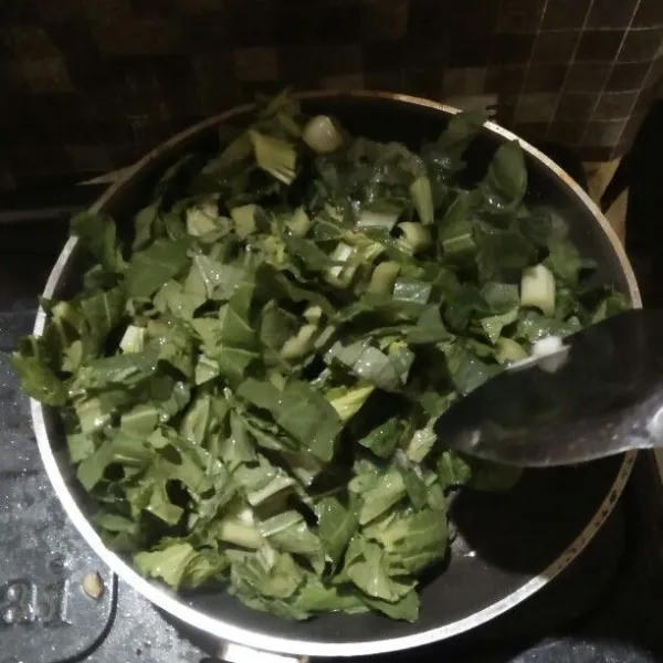 Masukkan sayur sawi. Aduk perlahan hingga layu.