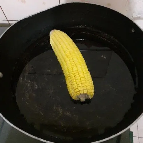 Cuci bersih jagung, lalu rebus hingga lembut, angkat dan tiriskan. Jangan buang air sisa rebusan.