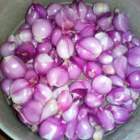 Kupas 1/4 kg bawang merah lalu iris tipis kecil-kecil.