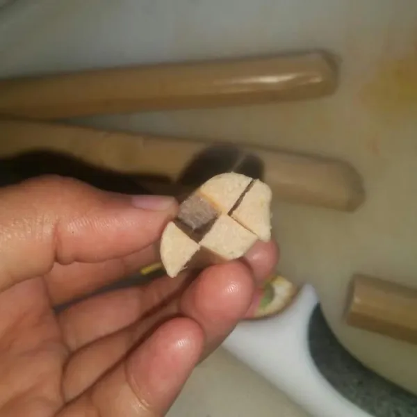 Potong sosis lalu belah sebagian ujungnya.