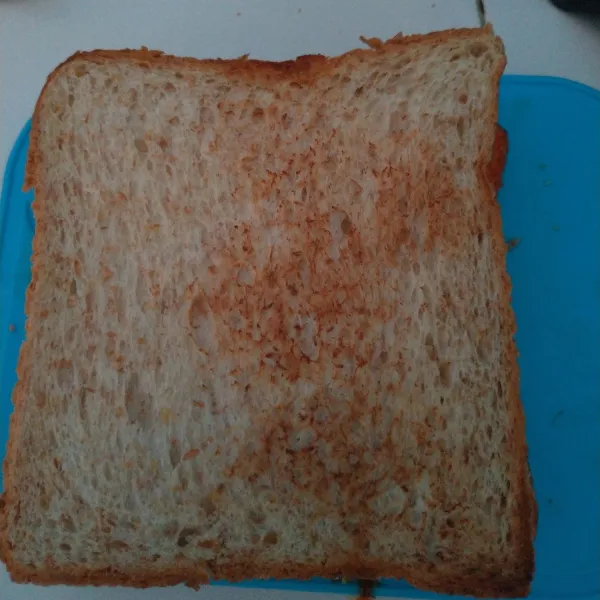 Kemudian tutup lagi dengan roti, belah menjadi 4 potong.