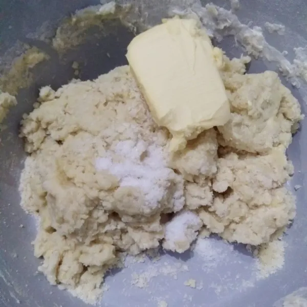 Masukkan garam dan margarin, kemudian mixer lagi hingga adonan kalis.