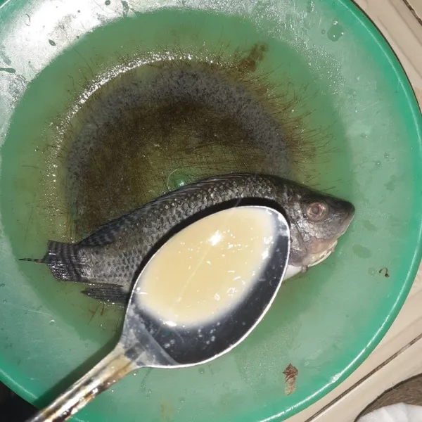 Bersihkan ikan nila, lumuri dengan air lemon dan garam.