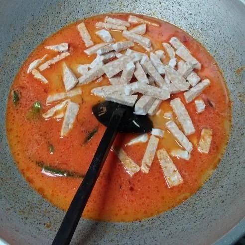 Masukkan tempe, garam, gula, dan kaldu bubuk, aduk rata dan masak hingga bumbu meresap.