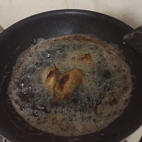 Panaskan minyak, goreng ayam dengan api kecil sampai matang lalu angkat dan tiriskan.