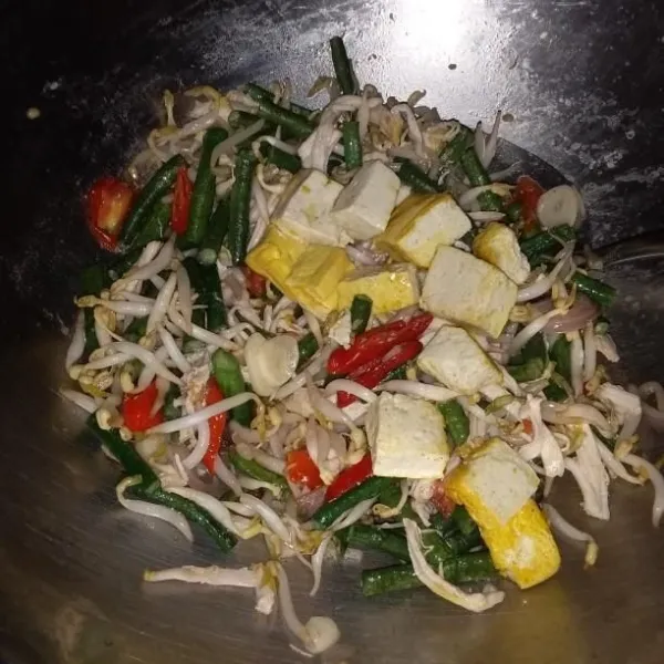 Masukkan taoge dan tahu. Aduk rata, masak hingga sayuran layu.
