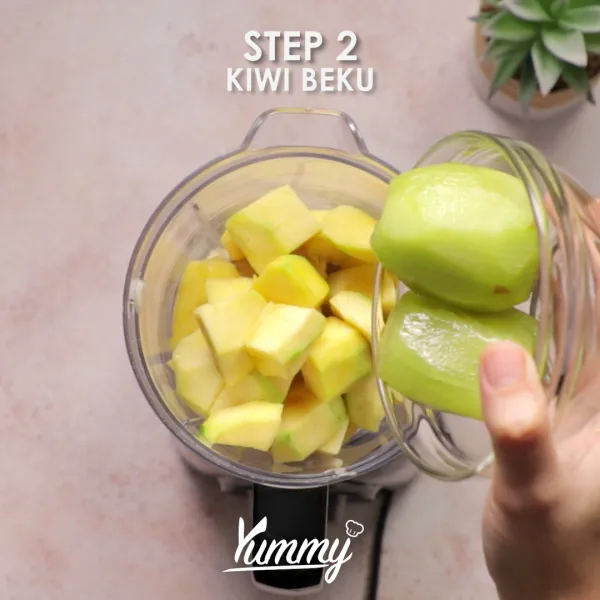 Masukkan buah kiwi beku, juice jeruk, dan buah kelapa kering.