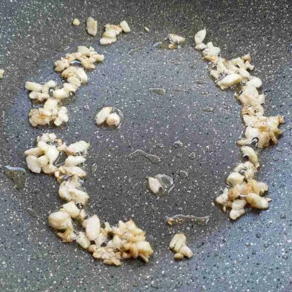 Tumis bawang putih dan merica bubuk sampai wangi kecokelatan.