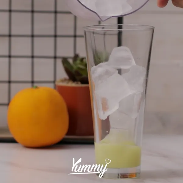 Masukkan susu kental manis ke dalam gelas, lalu tambahkan es batu hingga penuh.