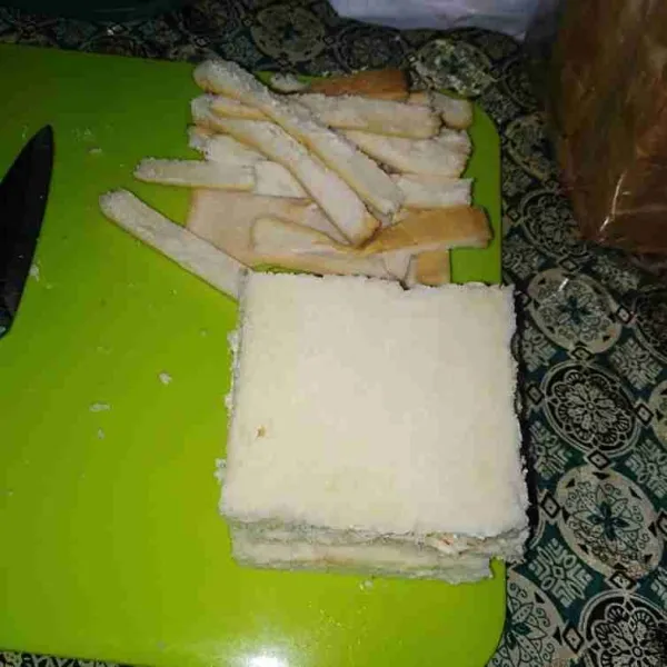 Buang kulit roti tawar.