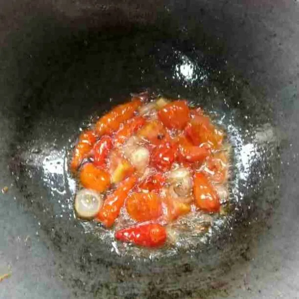 Goreng cabe rawit, bawang merah, bawang putih, dan tomat yang sebelumnya telah dipotong.