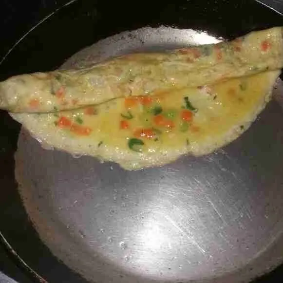 Gulung menggunakan spatula, sisakan sedikit bagian yang tidak usah digulung.