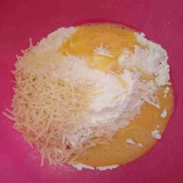 Pada wadah masukkan tepung tapioka, garam, keju parut, dan kocokan telur kemudian aduk rata.