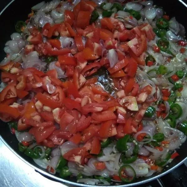 Masukkan potongan tomat lalu aduk hingga rata.