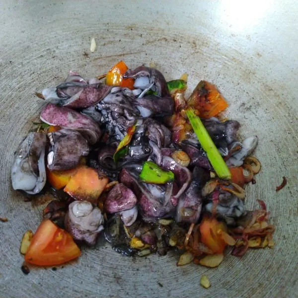 Masukkan tomat bersama cumi. Masak beberapa saat, sampai cumi berubah warna lalu tambahkan air secukupnya.