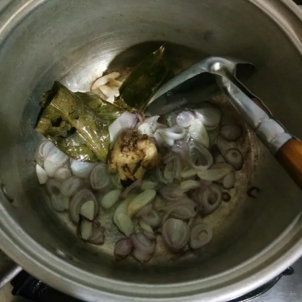 Panaskan minyak goreng dalam panci. Lalu masukkan bawang merah, bawang putih, lengkuas dan daun salam. Tumis hingga harum