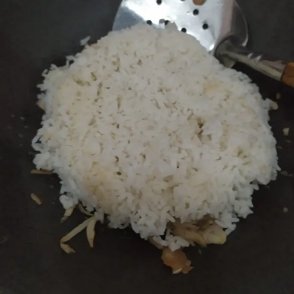 Masukkan nasi, gunakan nasi dingin yang sudah dimasukkan ke dalam chiller kulkas semalaman agar bumbu nasi goreng meresap sempurna