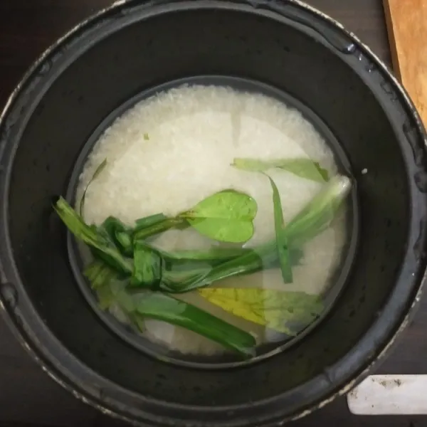 Cuci bersih beras putih. Masak dengan daun pandan dan daun jeruk