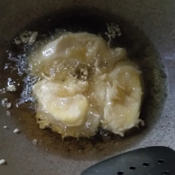 Setelah minyak panas, masukkan adonan pisang satu persatu, masak hingga kuning kecoklatan. Jika sudah matang, tiriskan.