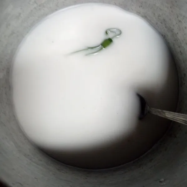 Siapkan panci: masukkan tepung beras, air, santan, garam halus, dan daun pandan. Aduk hingga benar-benar tercampur rata.