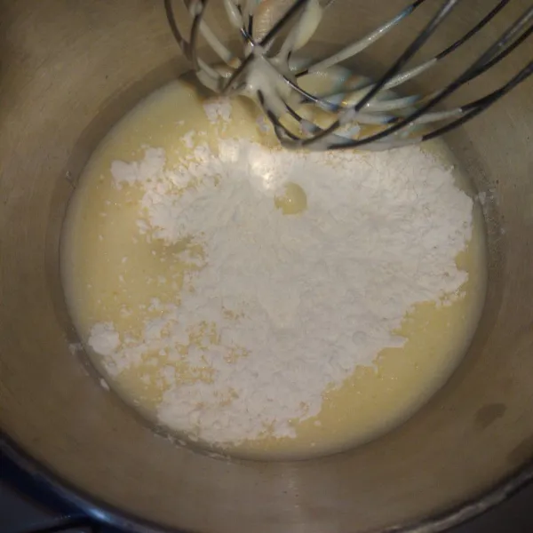 Tambahkan tepung terigu yang sudah diayak. Mikser dengan kecepatan rendah.