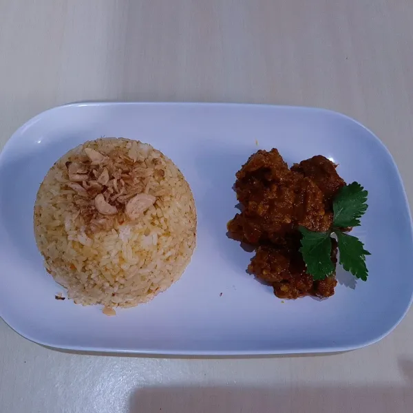 Matikan api, angkat dan sajikan daging rendang dengan nasi yang sudah dibalurkan sisa bumbu rendang di wajan