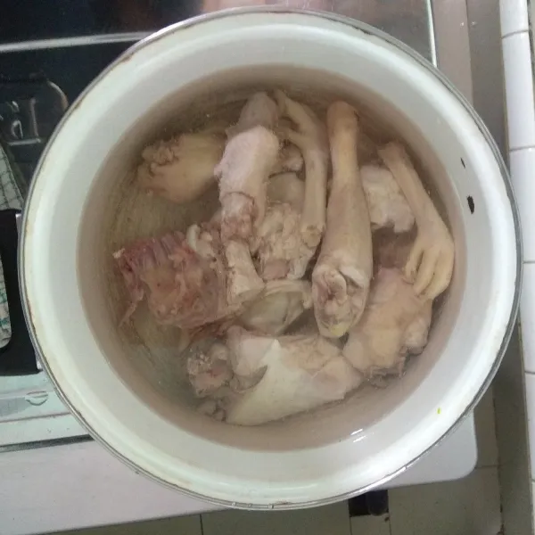 Masak air hingga mendidih, masukan ayam lalu rebus ayam dengan api kecil hingga ayam setengah matang.