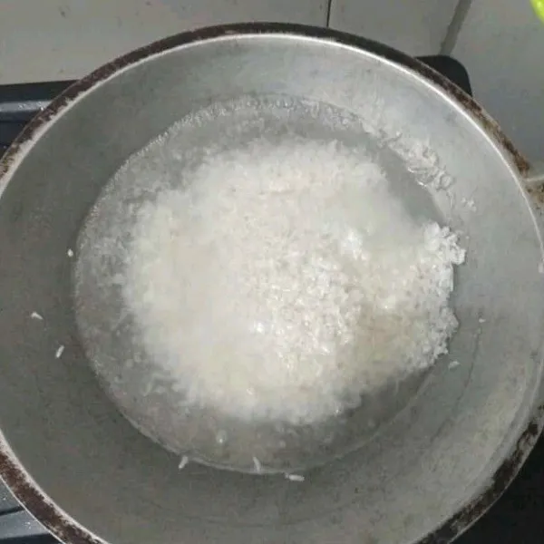 Masukkan beras yang sudah dicuci ke dalam wajan/panci berisi air lalu aduk hingga menjadi bubur, tambahkan sedikit garam, gula, dan penyedap rasa.
