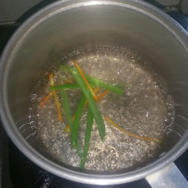 Cuci bersih buncis dan wortel. Potong memanjang dan rebus selama 3 menit, tiriskan.
