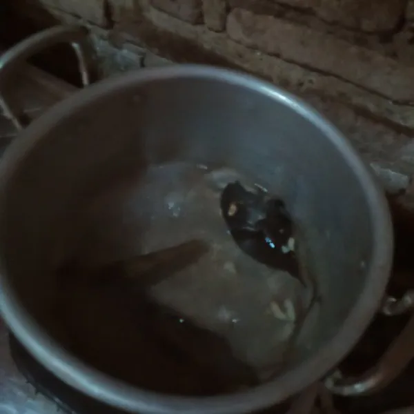 Rebus air hingga mendidih, masukkan bawang putih dan kencur yang sudah dipotong.