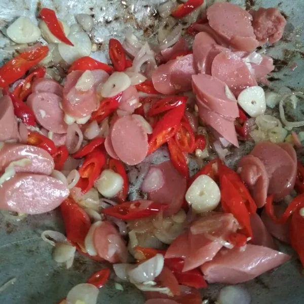 Tumis bawang merah, bawang putih, cabe merah hingga harum tambahkan potongan sosis masak hingga matang, sisihkan dipinggir