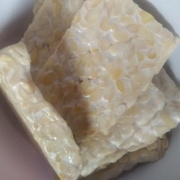 Potong tempe menjadi 10 bagian. Rendam dengan air garam lalu istirahatkan selama 15 menit
