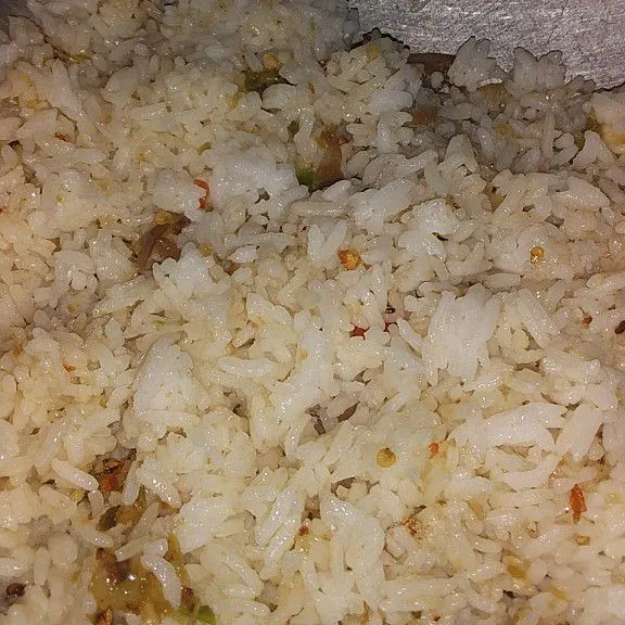 Masukan nasi, aduk rata. Tambahkan garam dan penyedap rasa, terus goreng hingga nasi sedikit kering. Sisihkan