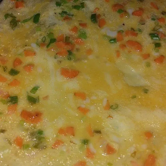 Kocok lepas telur, wortel, daun bawang dan beri sedikit garam. Lebarkan dan goreng hingga matang (jangan overcook)