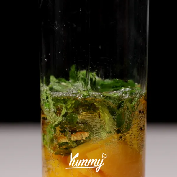 Tambahkan apel soda ke dalam gelas lalu tambahkan es batu secukupnya.