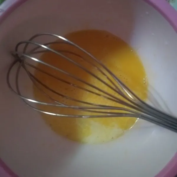 Aduk kuning telur, tambahkan susu dan vanili ekstrak, aduk lagi