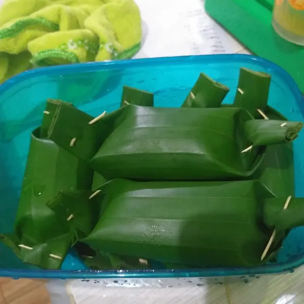 Bungkus dengan daun pisang dan semat dengan lidi.