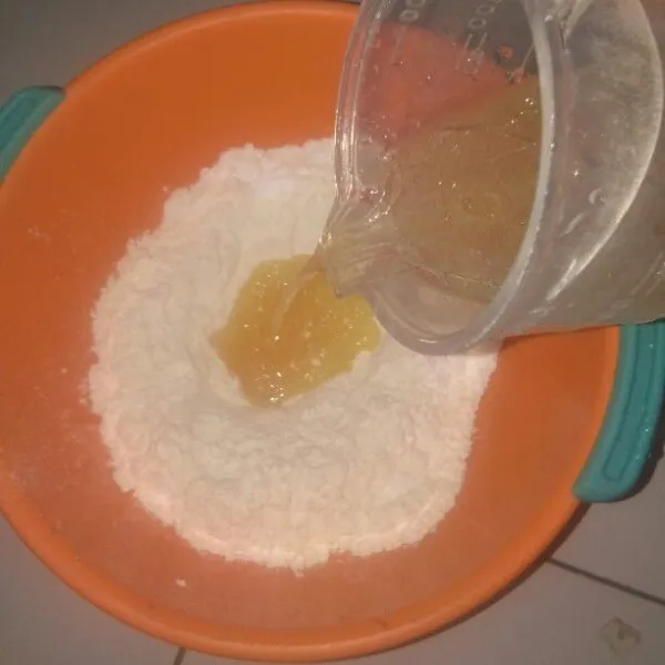 Kemudian tuangkan bahan basah (campuran air & minyak sayur) ke dalam bahan kering.