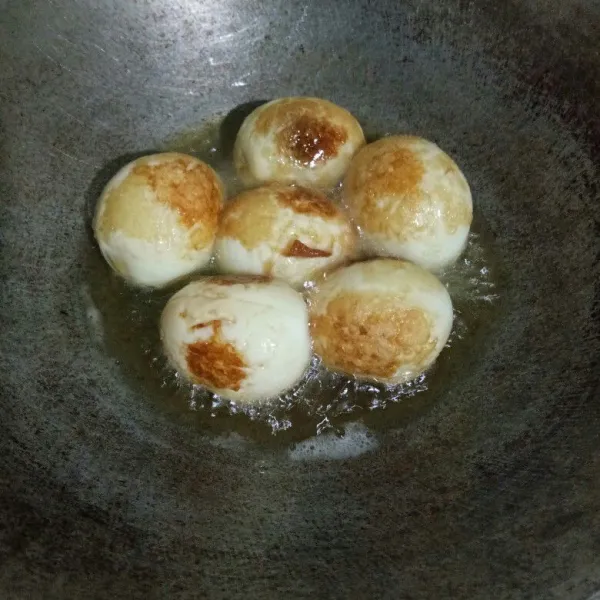 Panaskan minyak goreng, goreng telur hingga berkulit, tiriskan