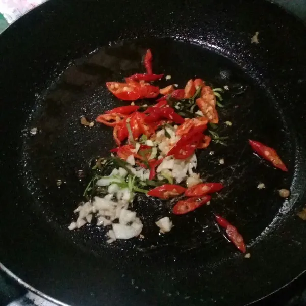 Tumis bawang putih cincang, cabe rawit merah iris, dan daun jeruk sampai sedikit kering, aduk rata
