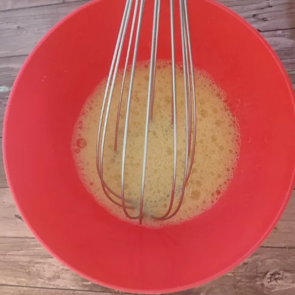 Campur gula pasir dan telur. Kocok dengan balloon whisk sampai gula larut.