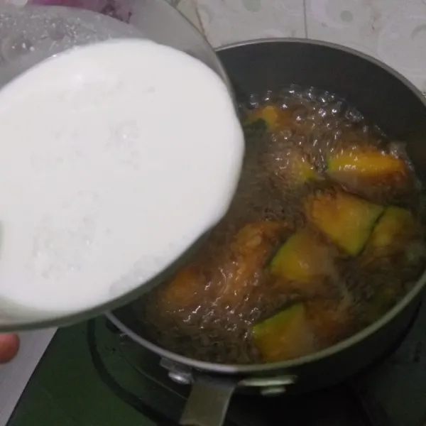 Setelah gula larut masukkan santan dan masak sambil sesekali diaduk.