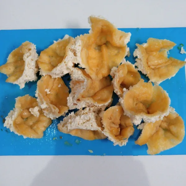 Potong segitiga tahu coklat kemudian balik.