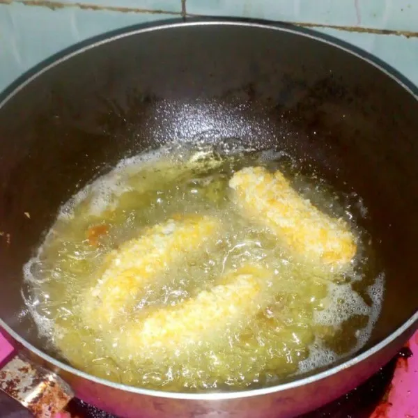 Panaskan minyak, goreng pisang hingga matang lalu angkat, beri susu kental manis dan taburan keju di atasnya. Sajikan selagi hangat.