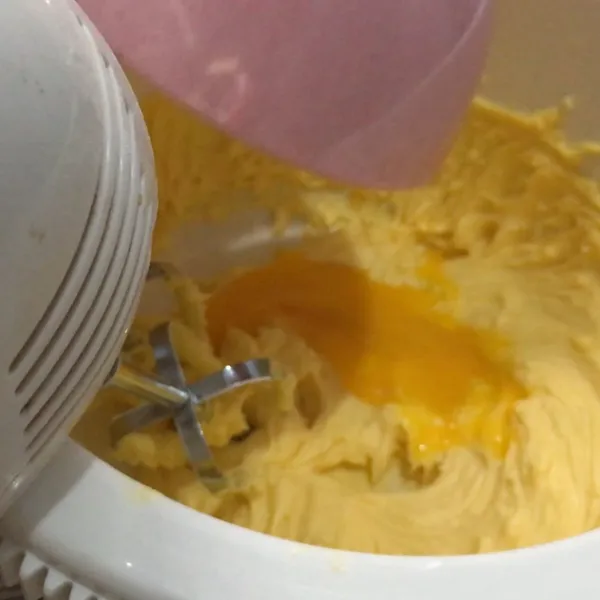 Masukkan kuning telur dan lanjutkan mencampurkan menggunakan mixer.