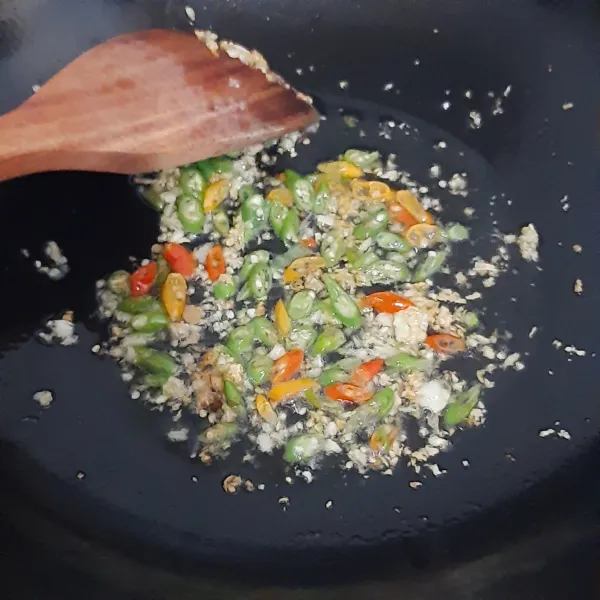 Panaskan minyak sayur, masukkan bawang putih yang sudah dihaluskan, dan cabai yang telah diiris aduk, tumis bumbu hingga harum.
