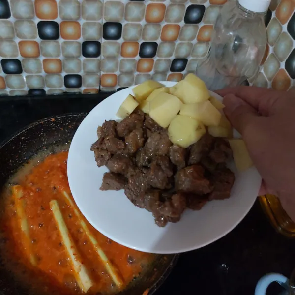 Masukkan potongan daging dan kentang, aduk hingga bumbu meresap.