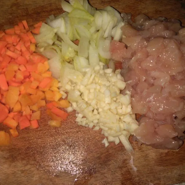 Potong wortel, ayam, bawang putih dan bombay.